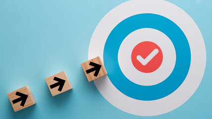 Business strategy and goal achievement concept with wooden blocks and target