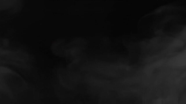 Abstract white smoke or vapor rising and swirling on a dark black background