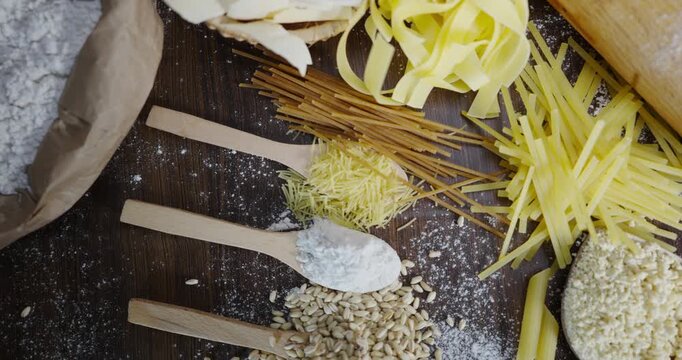 Top view of various types of delicious dry pasta and ingredients for making food on table, raw ingredients background concept, ready to cook concept.
