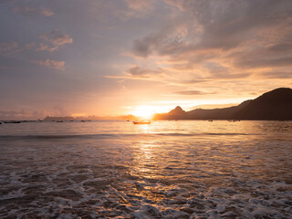 Golden sunset over calm ocean waters in Lombok Indonesia