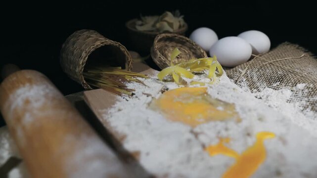 Pasta scene, eggs in mound of flour ready to make dough