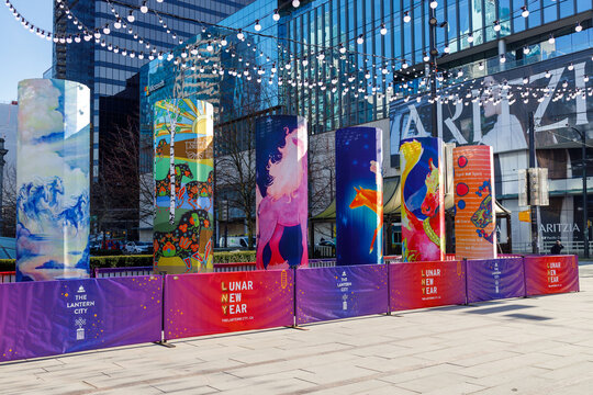 Lunar New Year art installation with colorful banners and string lights at downtown Vancouver plaza