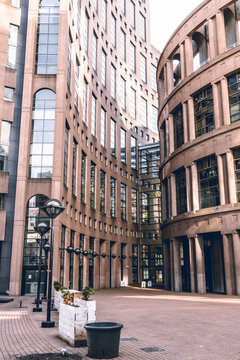 Vancouver Public Library interior courtyard with curved postmodern architecture, arched columns, brick plaza, planters and lamppost in downtown core