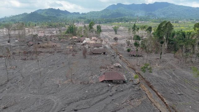 Aerial view of a village devastated by the lahar mudflow from the semeru volcano eruption. Destroyed houses and environment in java