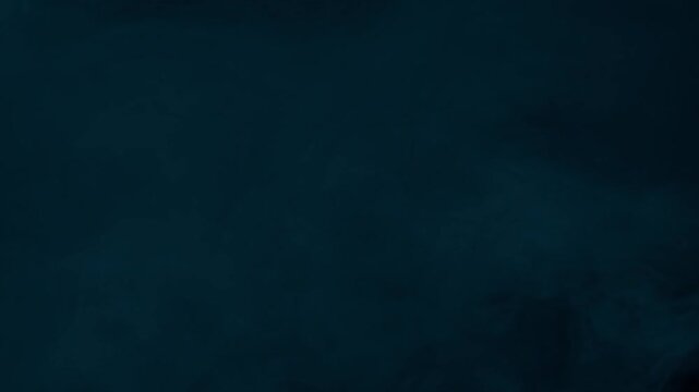 Dark and moody cyan fog fills screen, creating mysterious and cold atmosphere on black background
