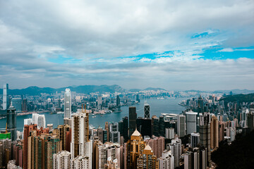 Obraz premium A breathtaking panoramic view of Victoria Harbour from the summit of Victoria Peak, capturing the iconic skyline, busy waterways, and the sprawling city of Hong Kong below.