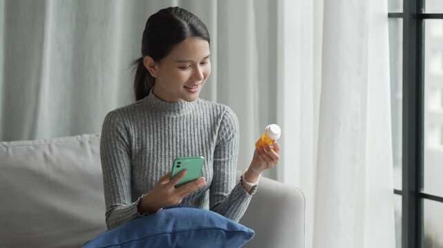 Asian Girl reading information online on mobile phone&nbsp;medicine