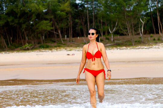 Woman with red bikini relax on beach
