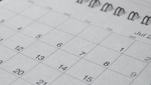 Flipping through calendar pages showing months August July June May April calendar sheets moving forward in time