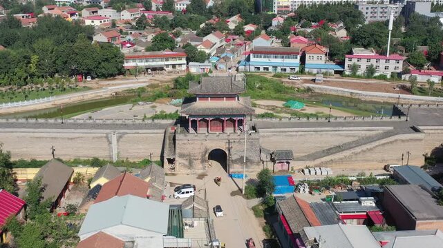 Breathtaking aerial footage of Guangfu Ancient City in Hebei, featuring well-preserved Ming Dynasty walls surrounded by moats, traditional architecture, and beautiful northern water town scenery.