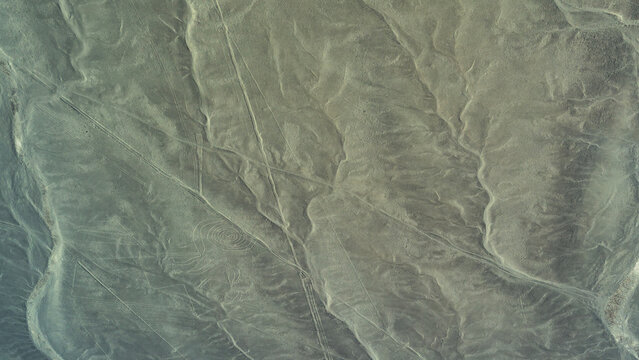 The Nazca Desert. Aerial view. An ancient geoglyph is visible on a sandy plateau - a giant drawing of a monkey with a spirally twisted tail. Peru. Nazca Lines