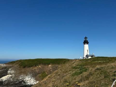 A lighthouse on the Pacific coast against a clear blue sky