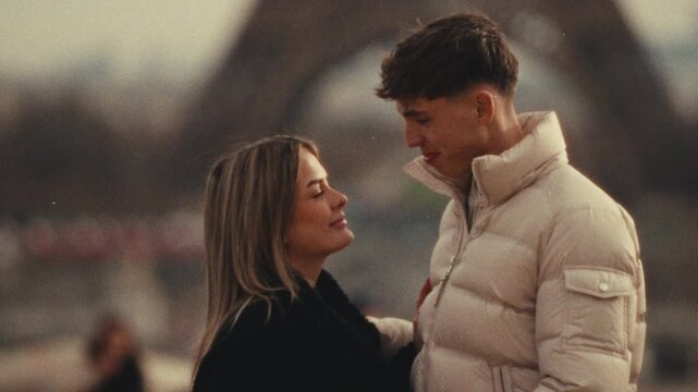 A romantic city trip concept A couple in love embraces in Paris France with the Eiffel Tower in the background Shot in a Super 8 film style with a handheld blurry and nostalgic aesthetic travel love s