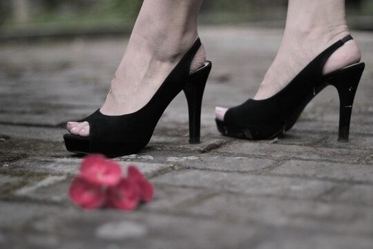 lady's feet wearing black heels, close up photo