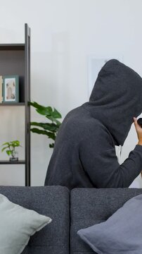 Asian Burglar in Hoodie Surprised by Accomplice in Living Room