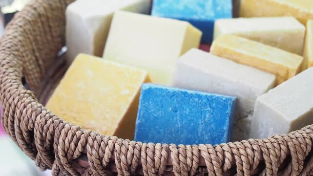 Assortment of artisanal soaps in wicker basket close-up