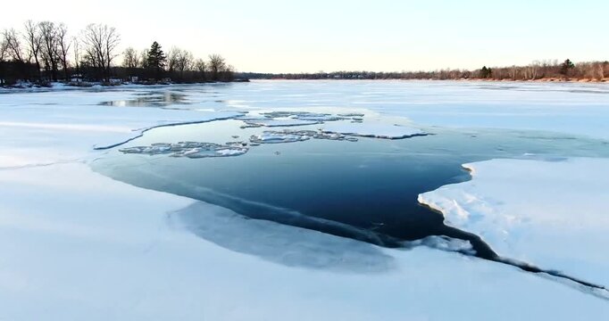 Frozen Lake with Ice and Trees Winter Landscape.