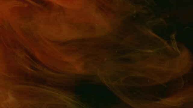 Cloud fume. Flowing paint. Blur orange smoke ethereal vapor water wave chemical liquid floating on abstract dark black acrylic background.
