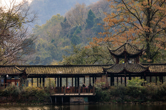 Traditional chinese walkway pavilion spanning serene water in china