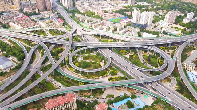 Stunning aerial drone footage of Xining city showcasing modern architecture, illuminated highway bridges, and vibrant night lights against the mountainous Qinghai landscape.