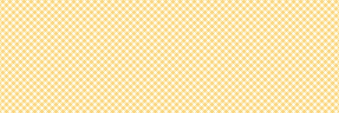 Yellow and white gingham check pattern background. Seamless diagonal plaid texture for picnic, kitchen, and spring summer fashion designs.