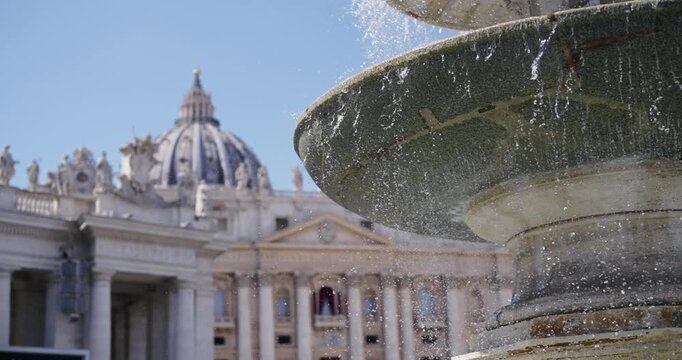 Cinematic view of foiuntain with colonnade of San Pietro. Vatican Rome, water flowing and spray in slow motion