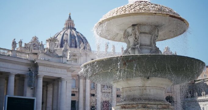 Cinematic view of slow motion flowing water at fountain Fontana del Bernini, sinistra in St. Peter's Square in St. Peter's Square, Vatican. Italy, Rome.