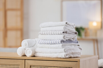Stack of clean towels on commode in room
