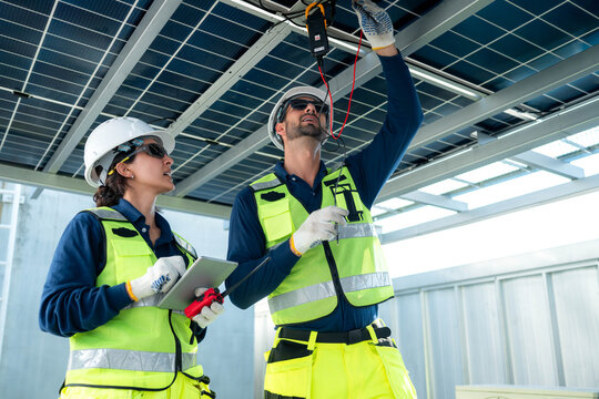 Engineering team measuring solar panel system performance