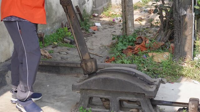 A person operating manual lever mechanism on points railway switch or a gate