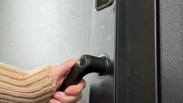 A woman opens a modern smart door lock with a digital keypad and biometric fingerprint access.