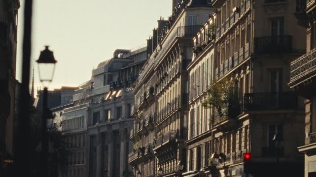 Evoking a romantic city trip showcasing a Paris street with classic architecture The handheld blurry Super 8 film style adds a vintage aesthetic travel vlogs documentaries or commercial projects seeki
