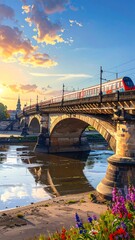Fototapeta premium A serene landscape with a train crossing a stone bridge over a river at sunset