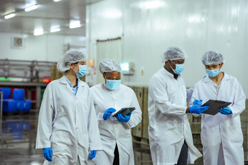 HACCP officers analyze documentation and evaluate procedures inside seafood production environment....