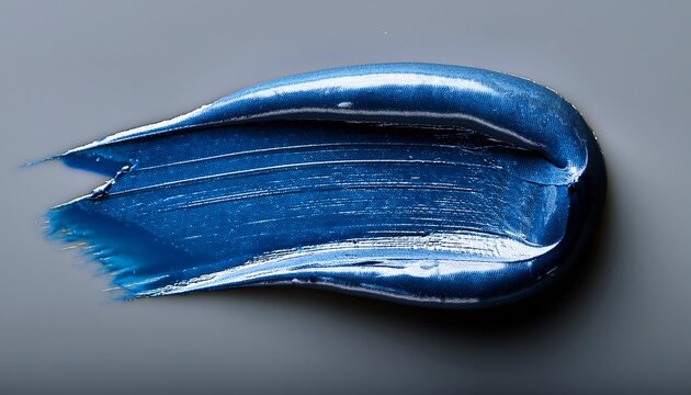 Close Up Of Blue Lipstick With Texture Smear On Grey Background