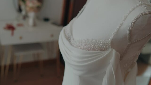 White bridal gown bodice with bead detail and draped fabric