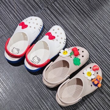 Creative collaboration of hello kitty and wiggle wiggle jibbitz charms for crocs footwear accessories made of plastic building blocks on a grey baseplate on May 12, 2024 in Bangkok, Thailand 