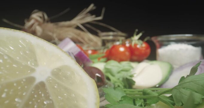 Healthy vegetables food concept scene of fresh cherry tomato, onion, parsley, cucumber, garlic and olives. Probe lens cinematic macro shot