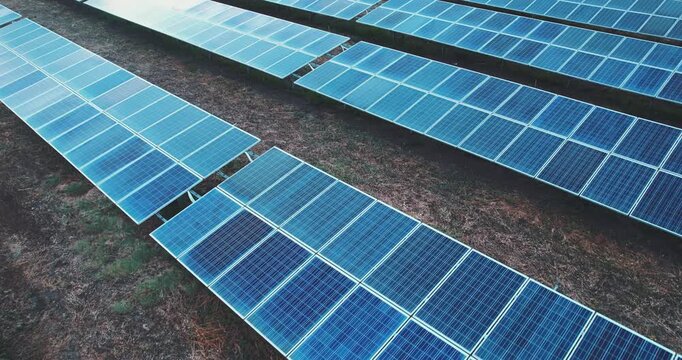 Aerial view of solar photovoltaic panels on a sunny day. power farm producing clean renewable ecological energy