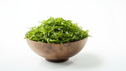 Fresh wakame seaweed in a wooden bowl on a white background. Japanese cuisine