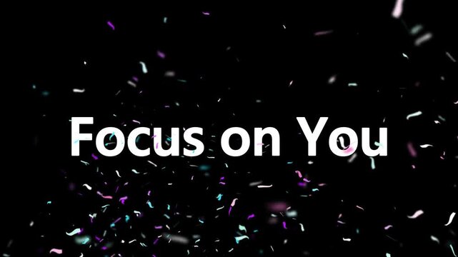 Glowing confetti particles fall against black background with focus on you text