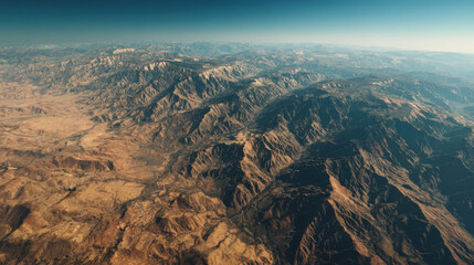 A vast desert landscape with mountains in the background. The sky is clear and blue, and the sun is shining brightly. Concept of emptiness and solitude, as the vast expanse of desert