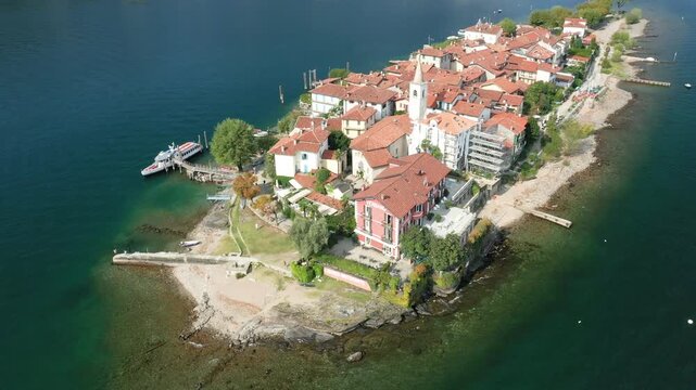 Scenic aerial view of Isola dei Pescatori with traditional buildings and tranquil waters, located on Lake Maggiore in Italy.
