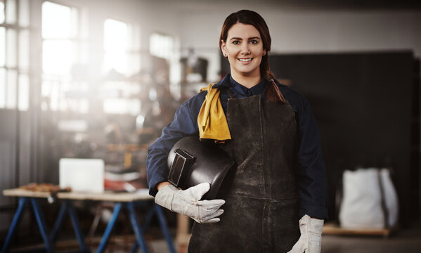 Design, portrait and smile of welder woman in office for manufacturing or production industry. Confident, helmet and trade profession with happy artisan person in welding workshop for craftsmanship
