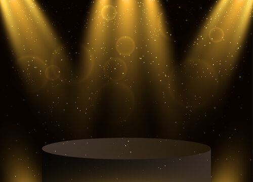 A brown cylinder on a stage with shining lights