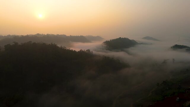 4K breathtaking dawn landscape showing bright morning sun glowing over heavy valley clouds