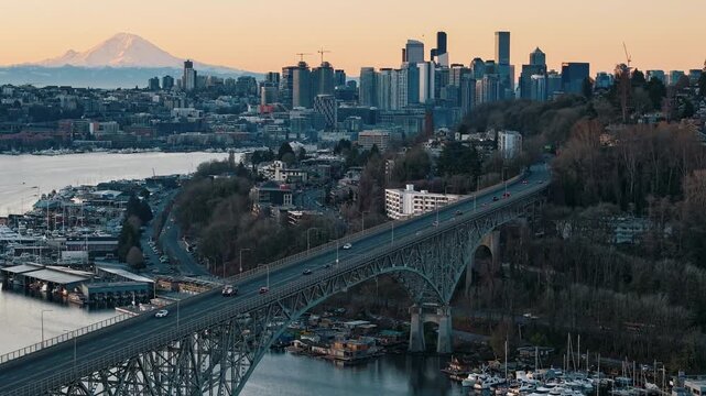 Sunrise timelapse over I-90 bridge with city and mountain beyond