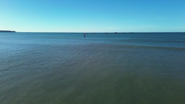 Drone Footage of Windsurfer Sailing in Asnelles with WW2 Mulberry Harbour in Background