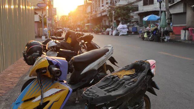 Sunset bathes alleyway in gentle glow amidst lively street activity