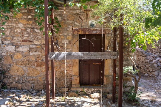 Stone courtyard and wooden door at Nea Moni Greek Orthodox monastery on Chios island, Greece